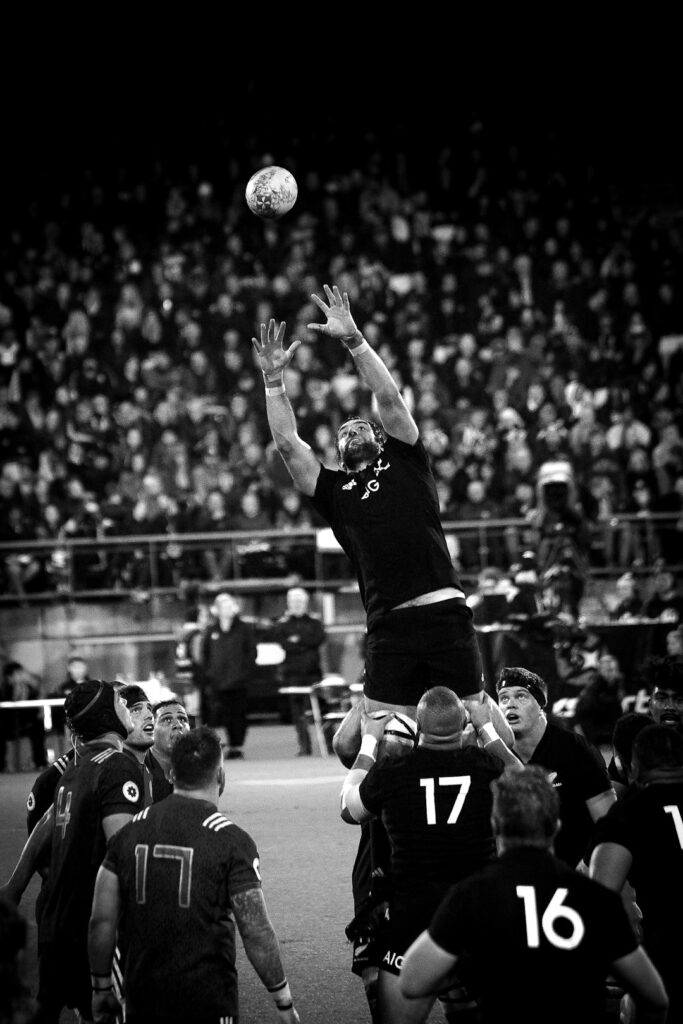grayscale photo of NFL player catching ball